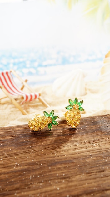 Yellow Gold Diamond Earrings Isolated on beach background