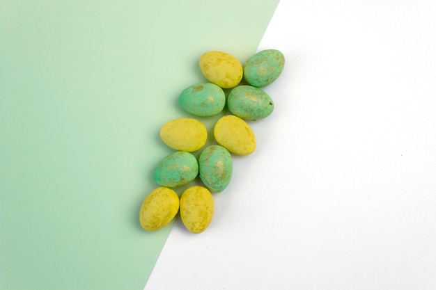 Yellow and green Easter eggs on a green and white background Place for text Geometry