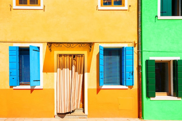 Yellow and green houses. Colorful architecture in Burano island near Venice, Italy