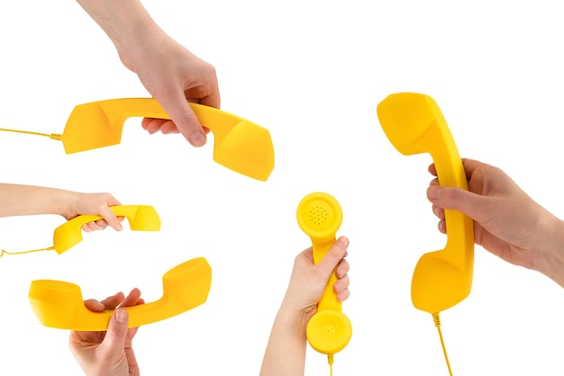 Yellow handset in woman hand isolated on white Copy space