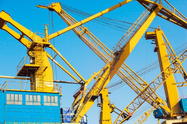 Yellow harbor cranes against the blue sky