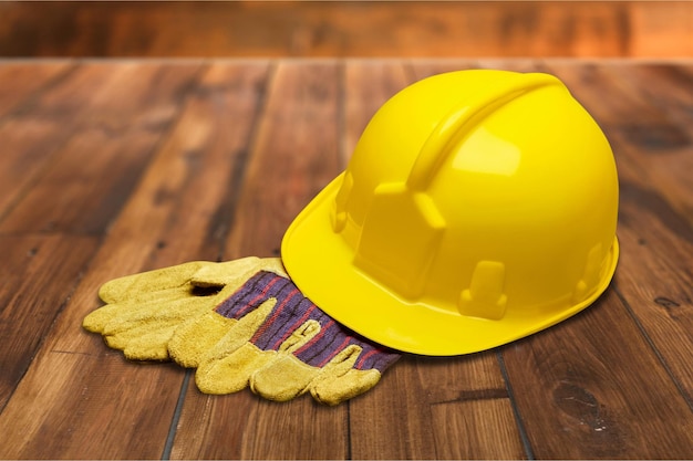 Yellow hard hat and leather work gloves