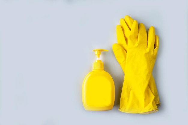 Yellow household gloves and liquid soap bottle copy space mockup