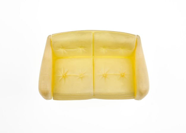 A yellow leather couch with a flower design on the top.