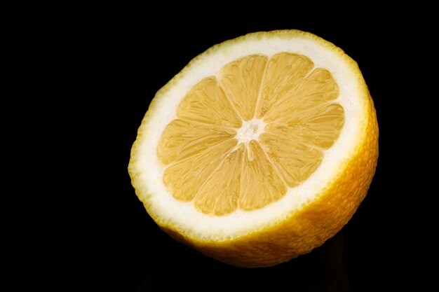 Yellow lemon closeup cut black surface