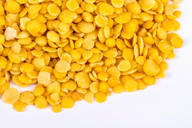 Yellow lentils isolated on white backgroundMacro shot