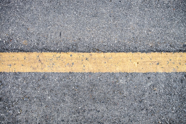 Yellow line on asphalt road texture