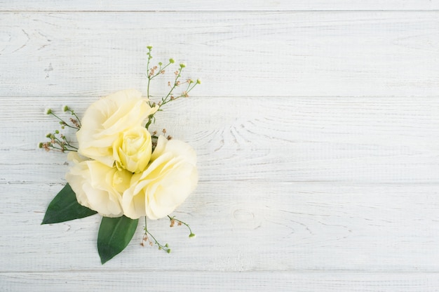 Yellow lisianthus flowers and lit candle