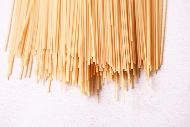 Yellow long spaghetti on white background