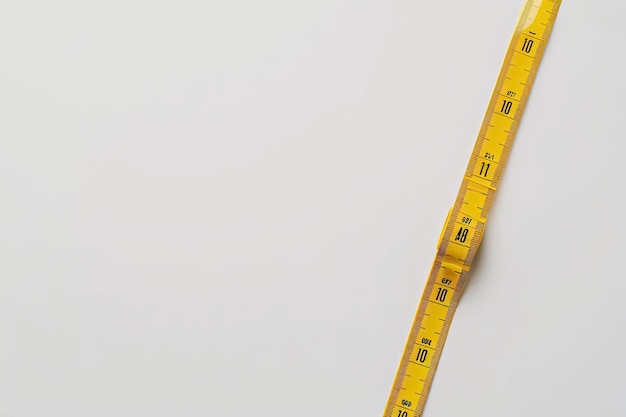 Photo a yellow measuring tape is shown on a white background