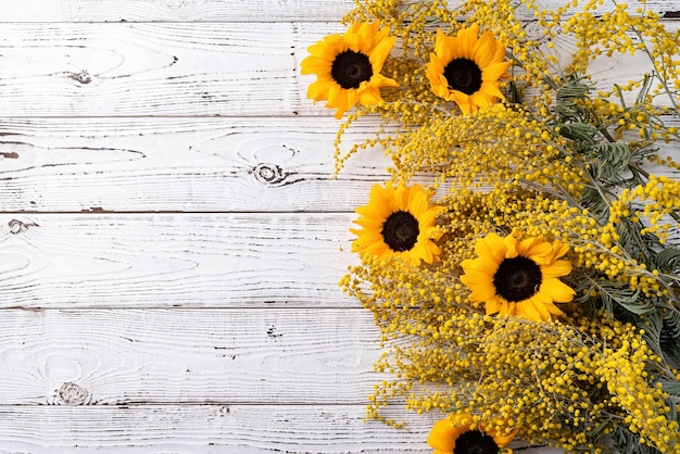 Yellow mimosa flowers bouquet on wooden bakground