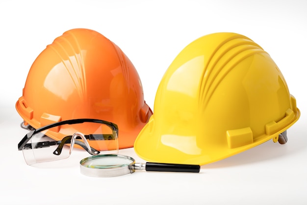 Yellow and orange construction helmet on white