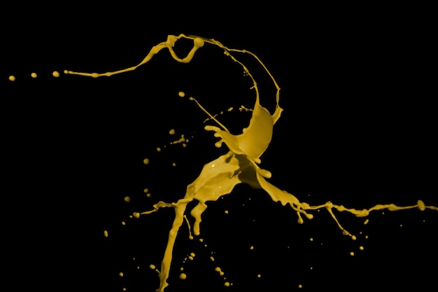 Yellow paint splashes isolated on black background