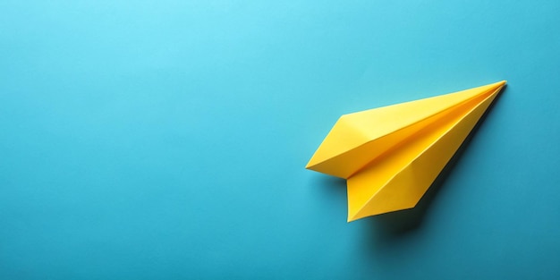 Yellow paper airplane on blue background