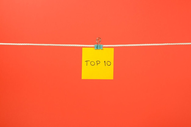 Yellow paper sheet on the string with text Top 10