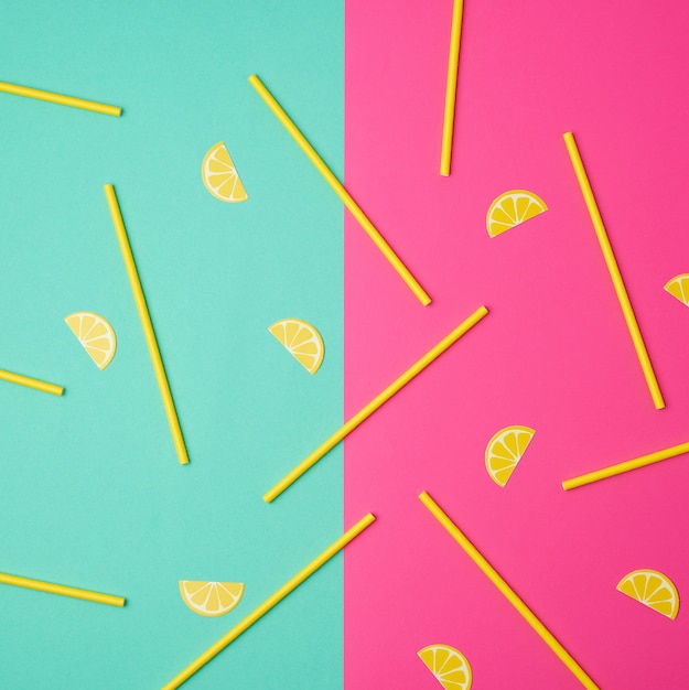 Yellow paper tubes for a cocktail on a multi colored background