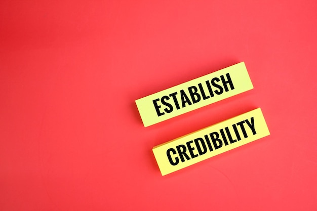 yellow paper with the words ESTABLISH CREDIBILITY. the concept of credibility