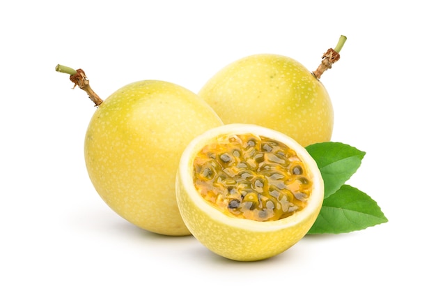 Yellow  passion fruit with cut in half and green leaf isolated on white background.