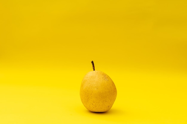 Yellow pears on a yellow background