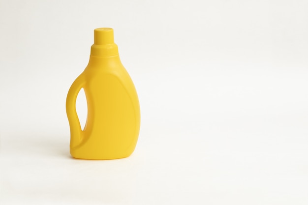 Yellow plactic bottle for detergent on a white backgraund