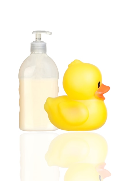 Yellow plastic duck and boat bath dispenser isolated on a over white background