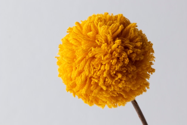 Yellow pom pom with white background