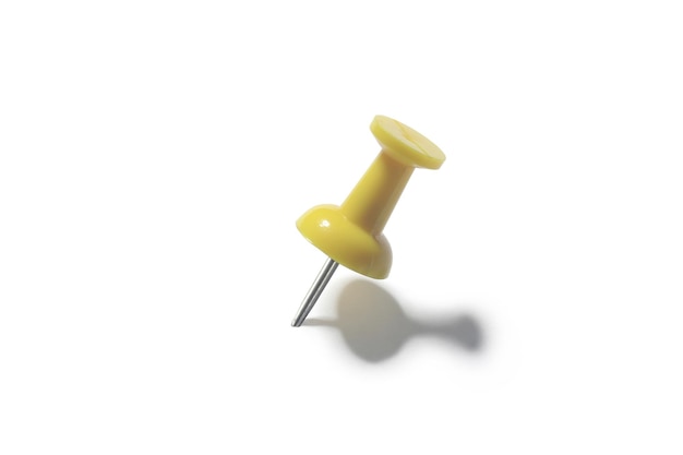 Yellow push pin on a white background