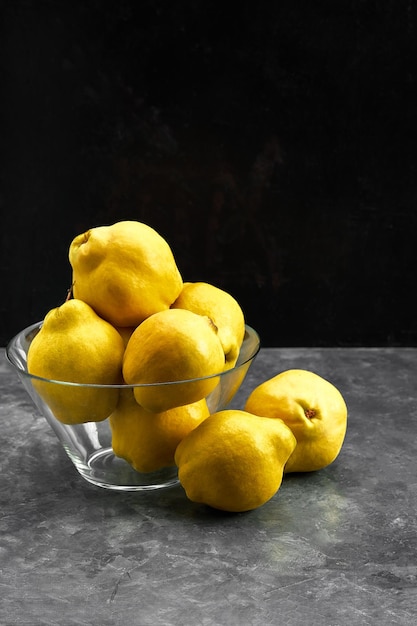 Yellow quince fruit isolated on black background.