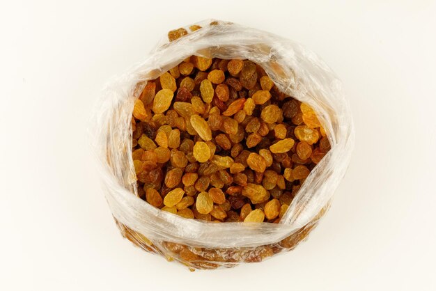 Yellow raisins dried fruits in a transparent ball