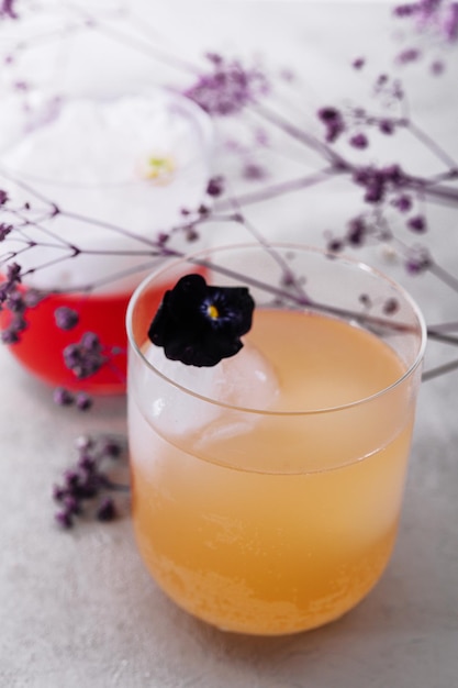 Yellow and red cocktails with a white foam