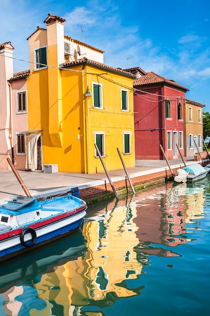 Yellow and red houses on the canal in Burano island Venice Italy