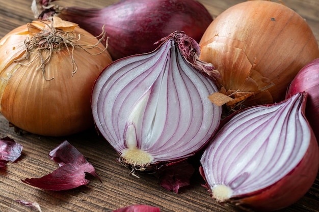 Yellow and red onions on a wooden board