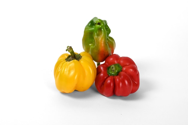 yellow and red and orange and green peppers white background