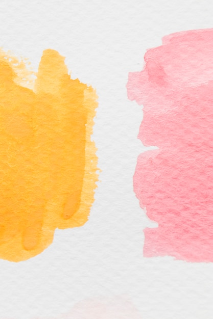 Yellow and red watercolor splotch on white paper