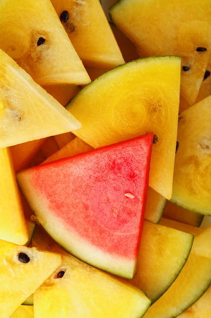 Yellow and red watermelon cut into slices. 