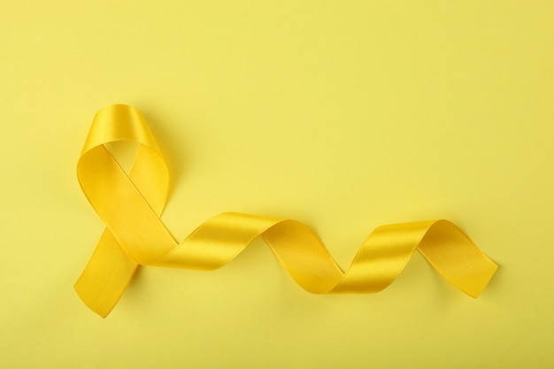 Yellow ribbon symbolizing cancer in children top view