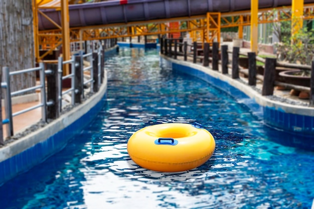 Yellow ring floating in a blue wave water on the canal in swimming pool Summer holidays