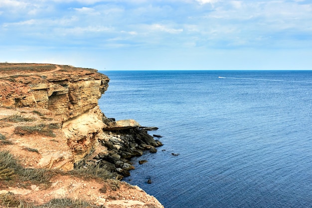 Yellow rocky seashore cliff Blue deep calm sea Crimea Tarkhankut