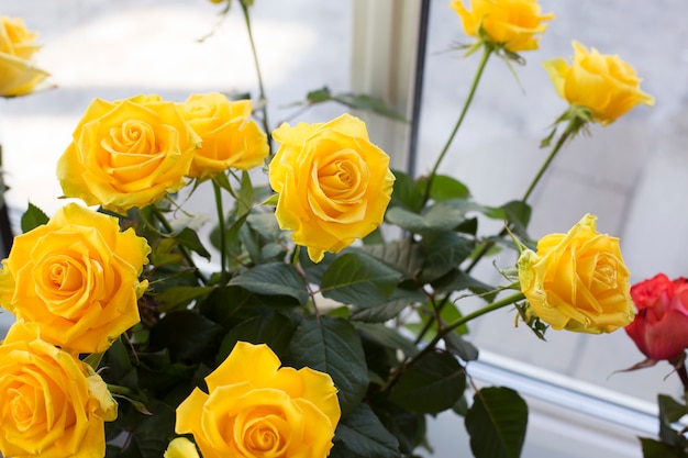 Yellow roses in a flask in a flower shop. Concept of selling flowers