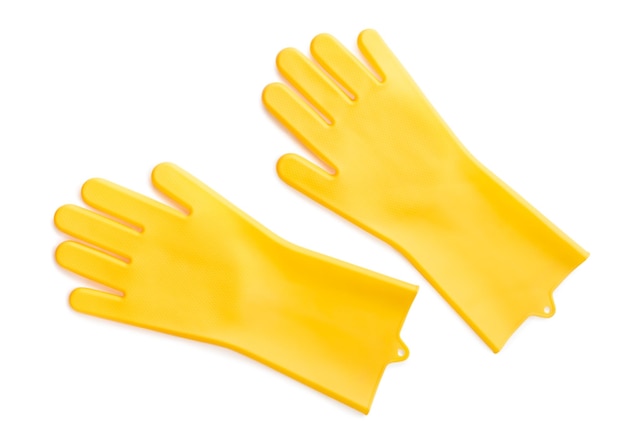 Yellow rubber gloves for cleaning isolated on white background