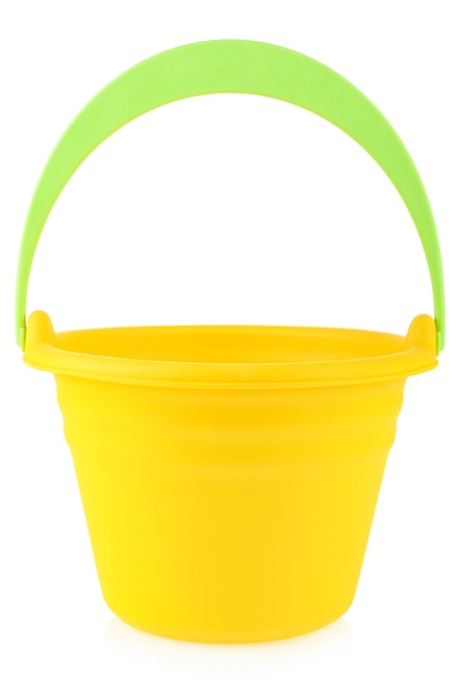 A yellow rubber or plastic baby bucket with a green handle on a white background Bucket for playing in the sandbox or on the sea Children's toys with space for your label or brand mockup