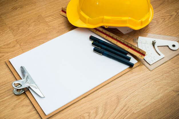 Photo yellow safety helmet hat and clipboard