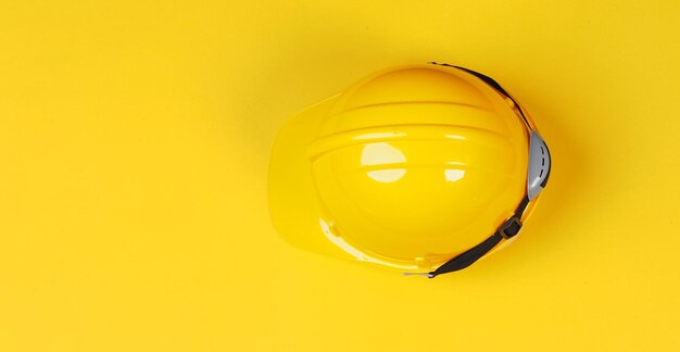 Photo yellow safety helmet on yellow backgroundx9