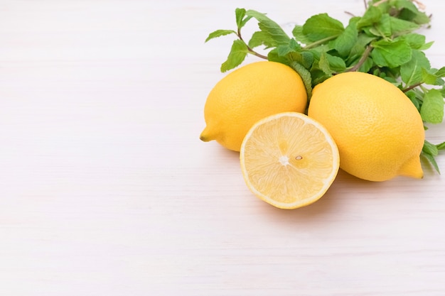 Yellow sliced lemon on wooden board