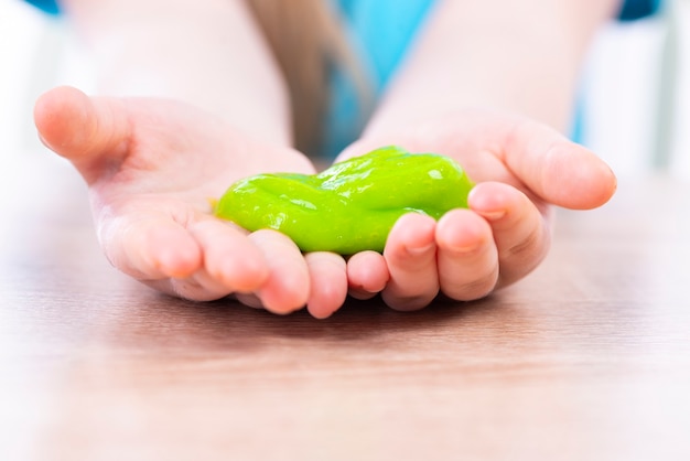 Yellow slime in the hands of a child