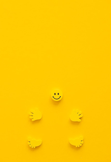 Photo yellow smile with hands and legs on yellow background