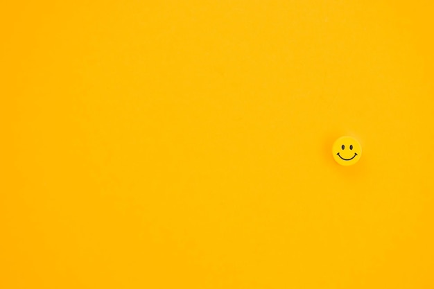 Yellow smile on yellow background