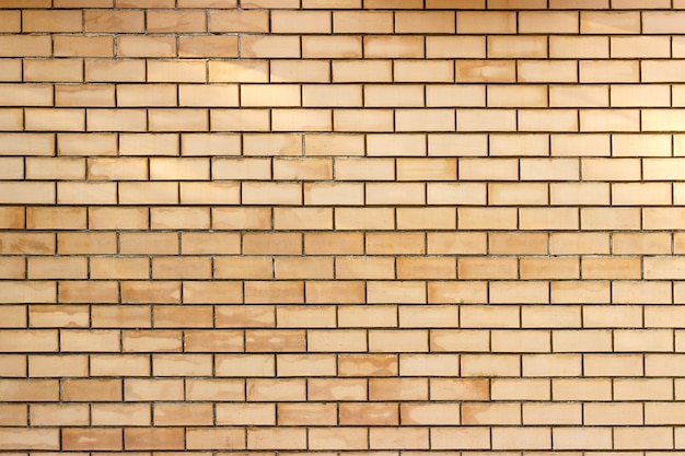 Yellow smooth brick wall background texture