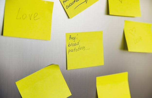 Yellow square stickers are glued to the refrigerator Sheets for recording information Reminders shopping list Empty space for the text