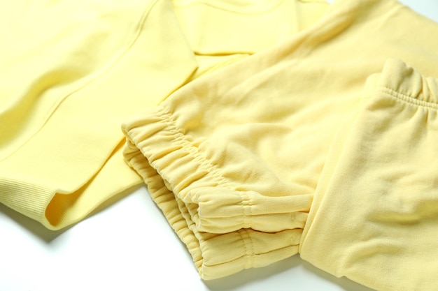 Yellow sweatshirt and sweatpants on white background